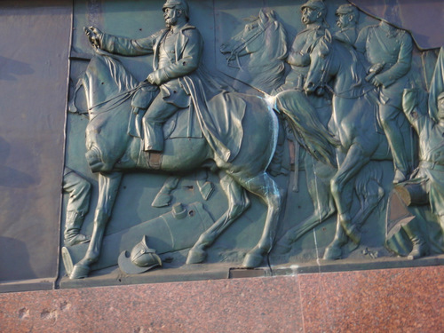 A closeup on the bronze reliefs.